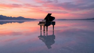 A grand piano floating in the middle of a salt fla